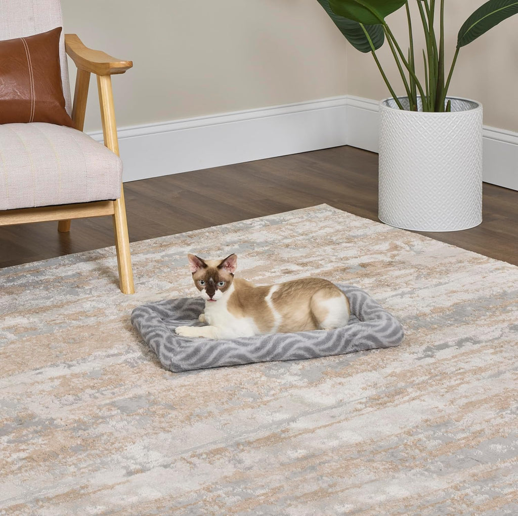 Elastic straps securing gray dog bed in crate